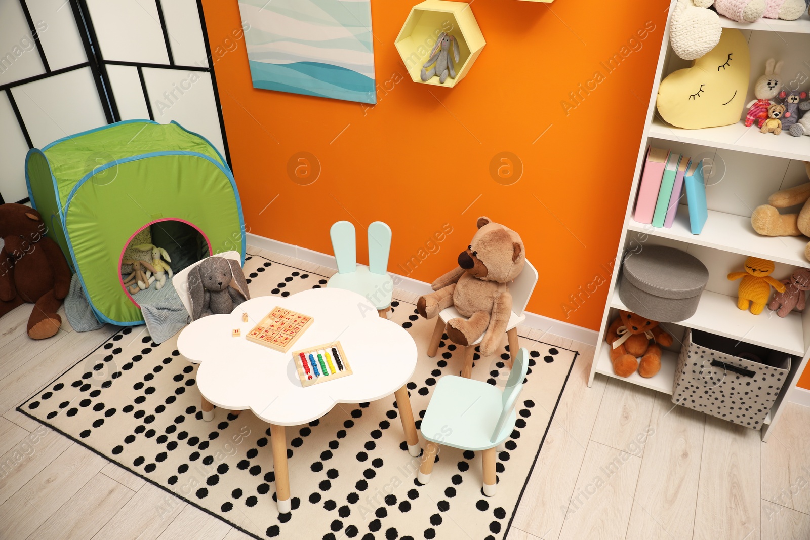 Photo of Stylish child room interior with different toys and furniture