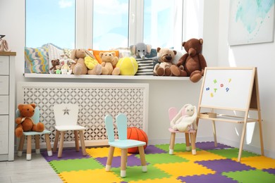 Photo of Stylish child room interior with different toys and furniture