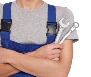 Photo of Auto mechanic with wrenches on white background, closeup