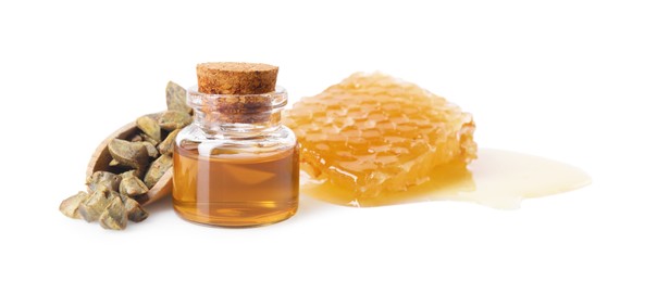 Photo of Natural honey tincture, propolis granules and sweet honeycomb isolated on white