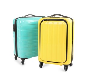 Photo of Two new yellow and light blue suitcases isolated on white