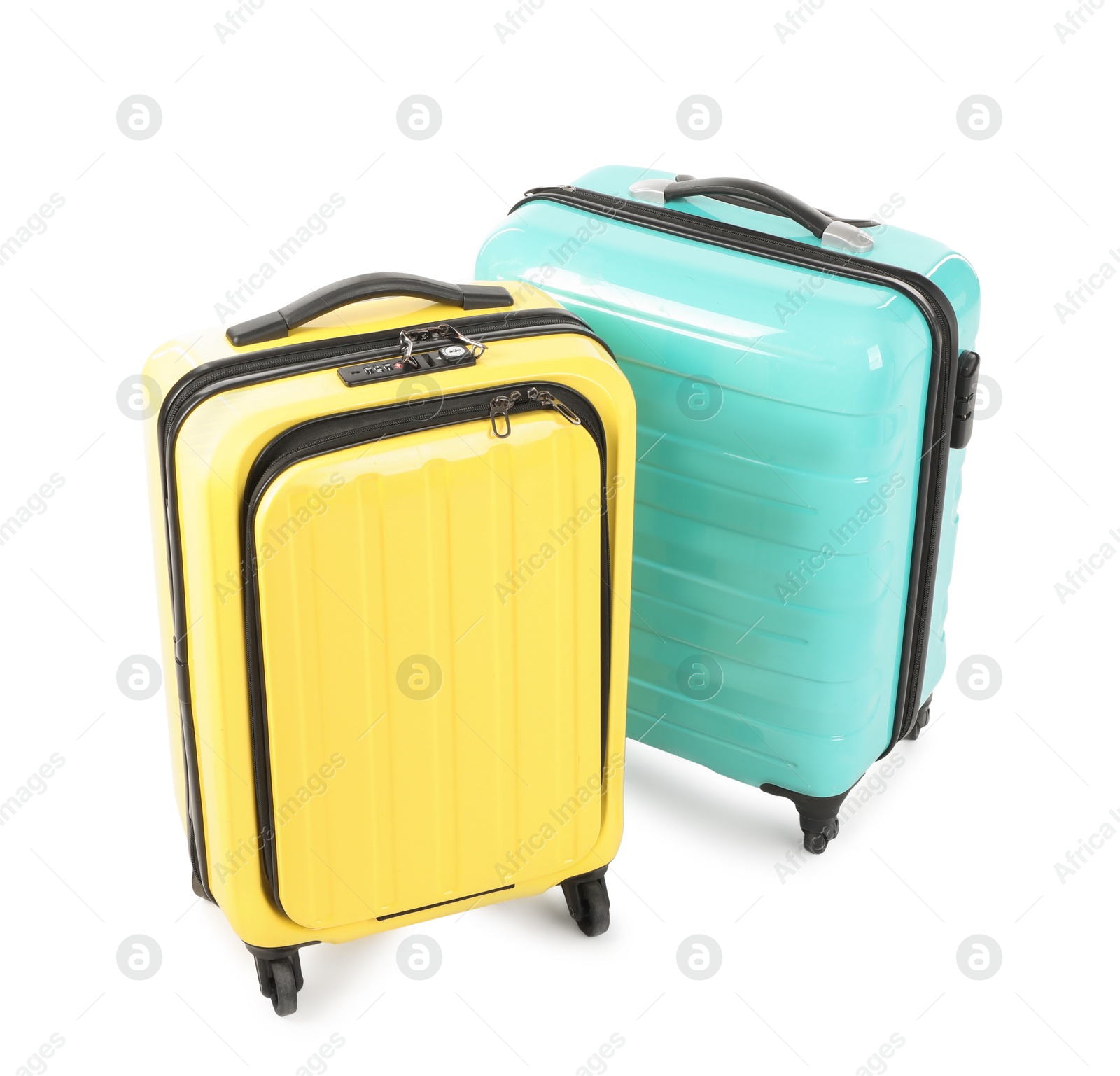 Photo of Two new yellow and light blue suitcases isolated on white