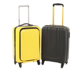 Photo of Two new yellow and black suitcases isolated on white