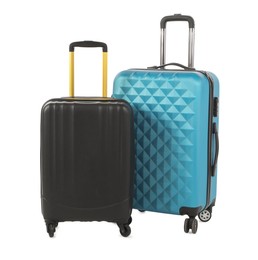 Photo of Two new light blue and black suitcases isolated on white