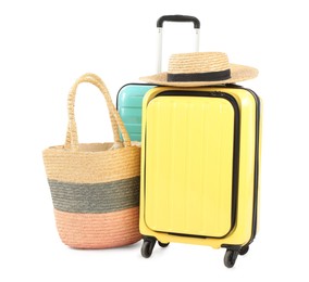 Photo of New suitcases, bag and straw hat isolated on white