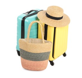 Photo of New suitcases, bag and straw hat isolated on white