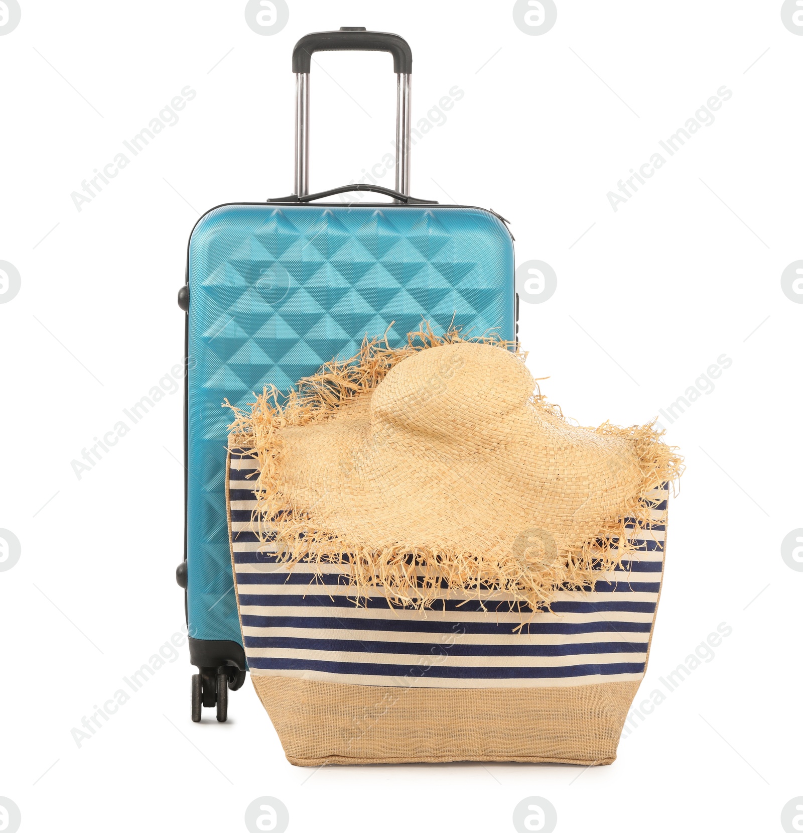 Photo of Light blue suitcase, bag and straw hat isolated on white