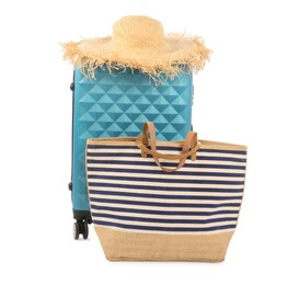 Photo of Light blue suitcase, bag and straw hat isolated on white