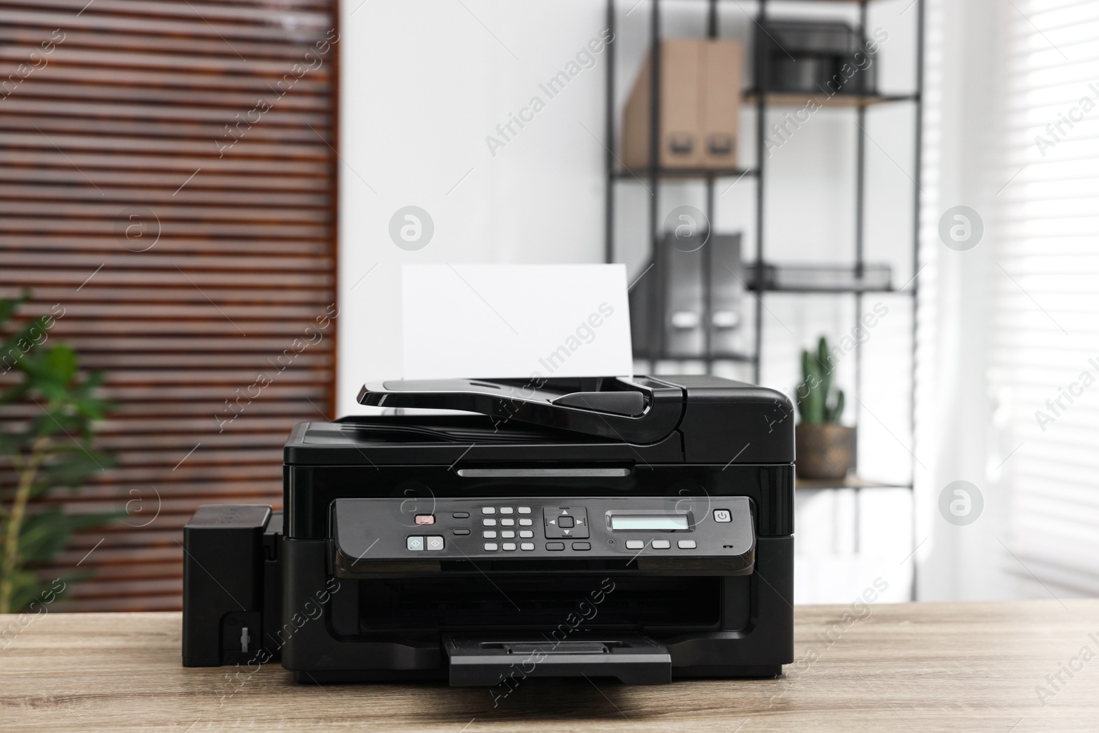 Photo of Modern printer with paper on table in office