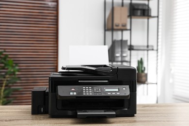 Modern printer with paper on table in office