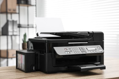 Photo of Modern printer with paper on table in office