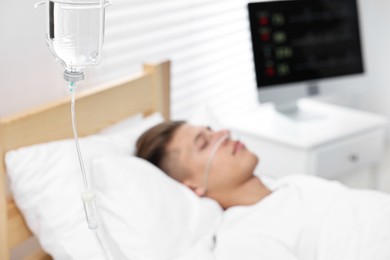 Coma patient. Young man sleeping in hospital bed, selective focus