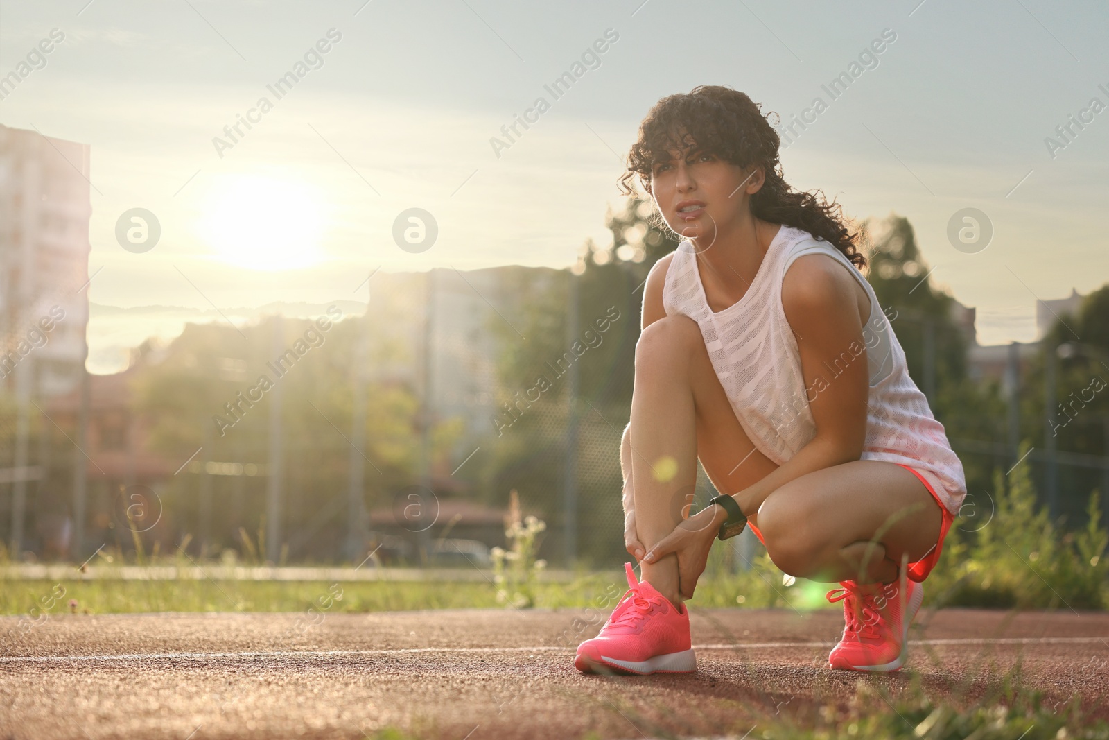 Photo of Sportswoman with leg injury at stadium, space for text