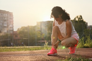 Photo of Sportswoman with leg injury at stadium, space for text