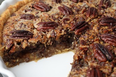 Delicious pecan pie in baking dish, closeup