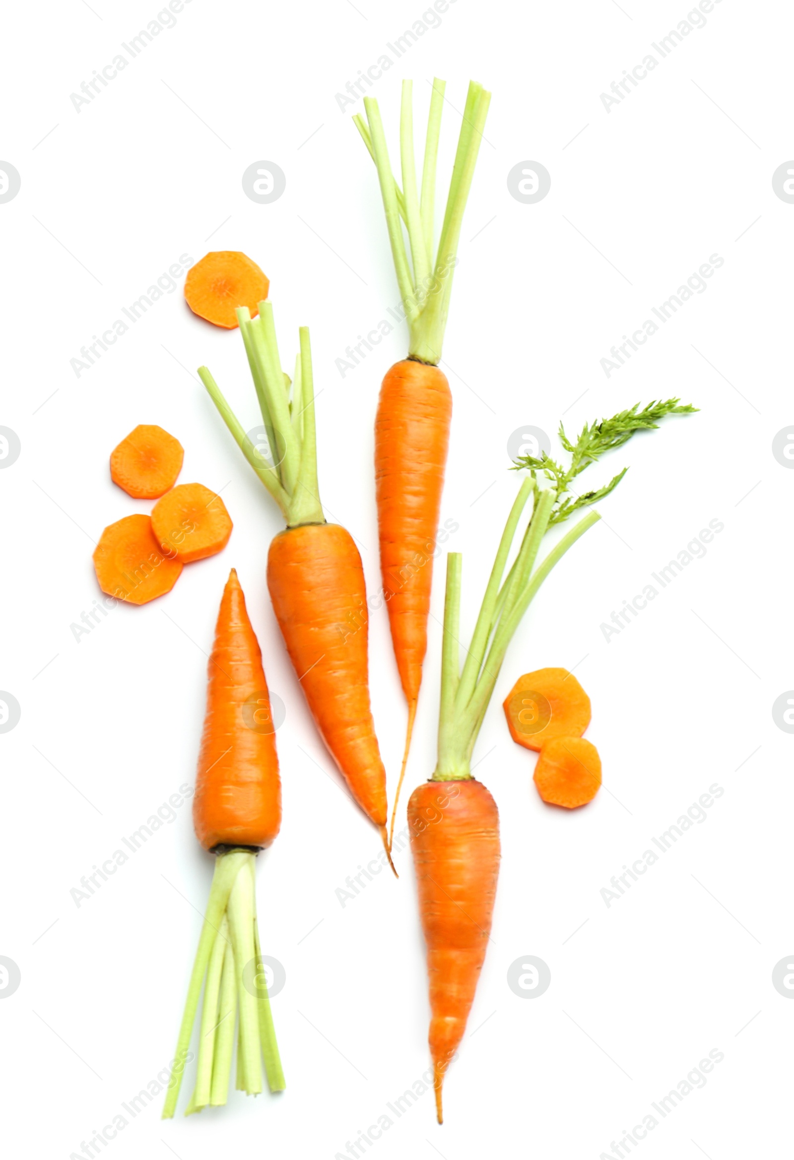 Photo of Whole and cut fresh carrots isolated on white, top view