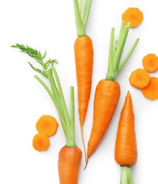 Whole and cut fresh carrots isolated on white, top view