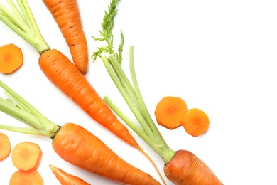 Whole and cut fresh carrots isolated on white, top view