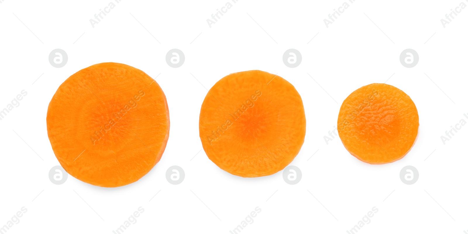 Photo of Slices of fresh ripe carrot isolated on white, top view