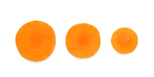 Photo of Slices of fresh ripe carrot isolated on white, top view