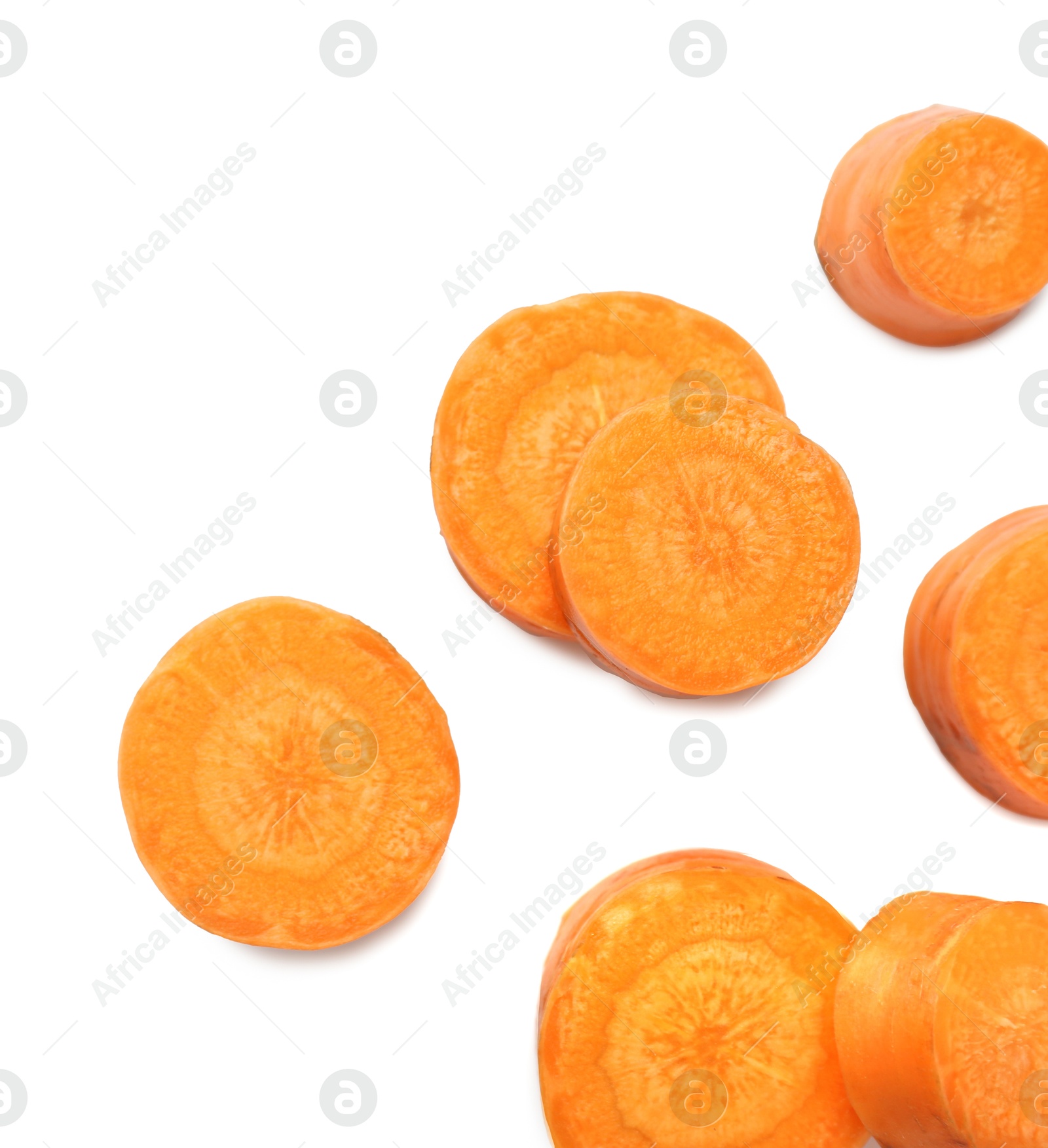 Photo of Slices of fresh ripe carrot isolated on white, top view