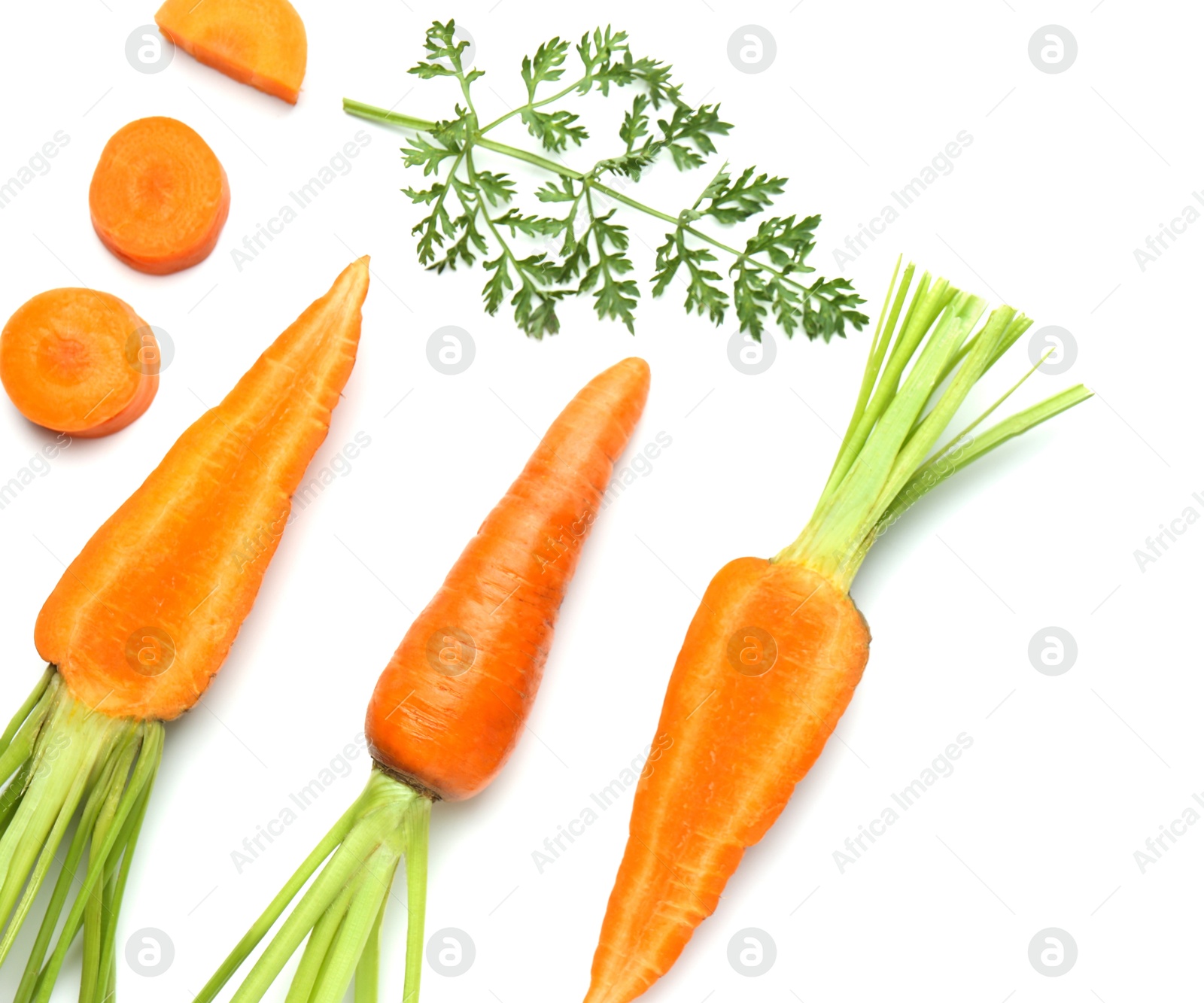 Photo of Whole and cut fresh carrots isolated on white, top view