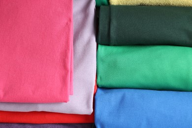 Different folded clothes as background, top view