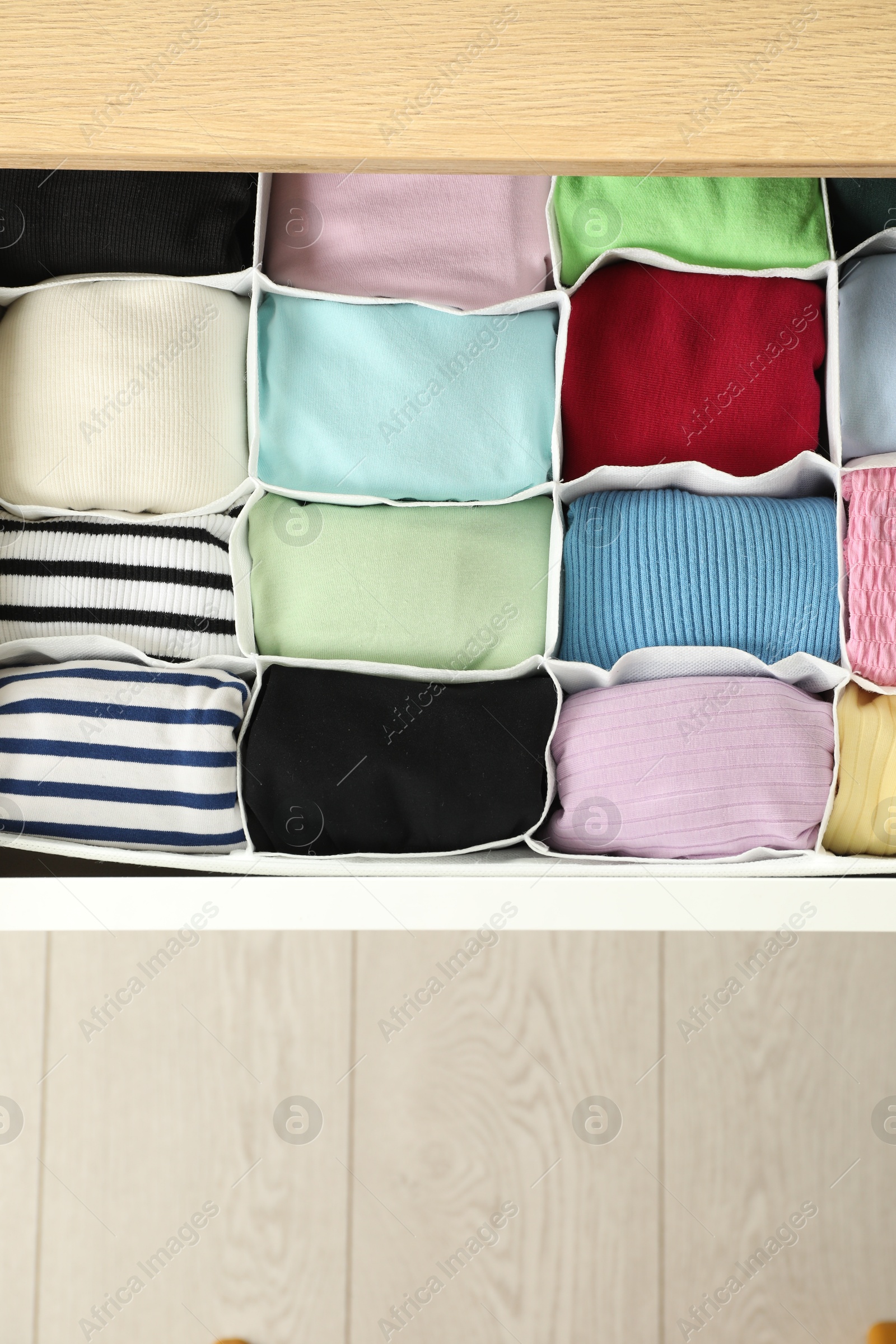 Photo of Chest of drawers with different folded clothes, top view