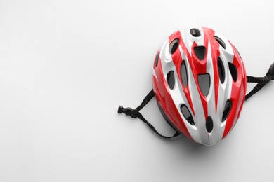 New stylish bicycle helmet on white background, top view. Space for text