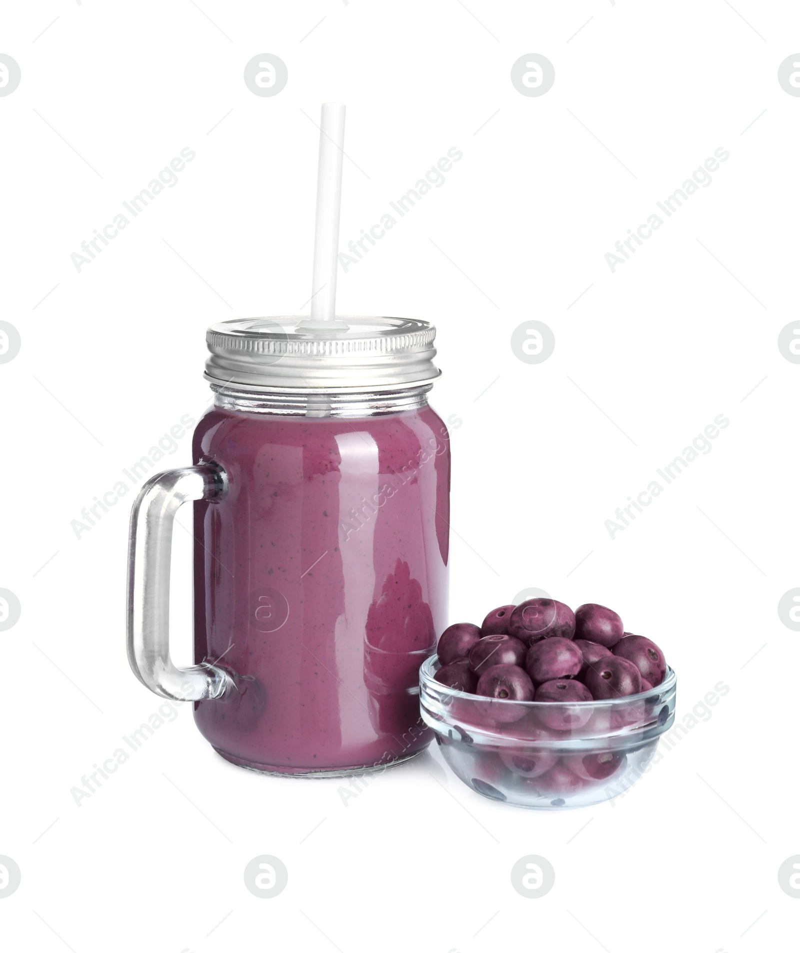 Photo of Tasty acai juice in mason jar and berries isolated on white