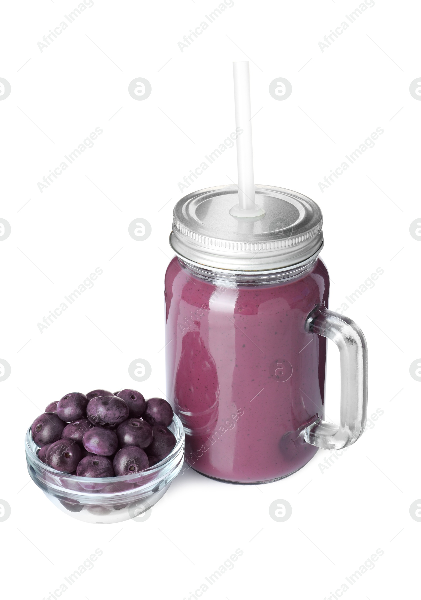 Photo of Tasty acai juice in mason jar and berries isolated on white