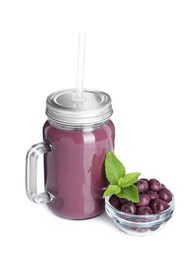 Photo of Tasty acai juice in mason jar, mint and berries isolated on white