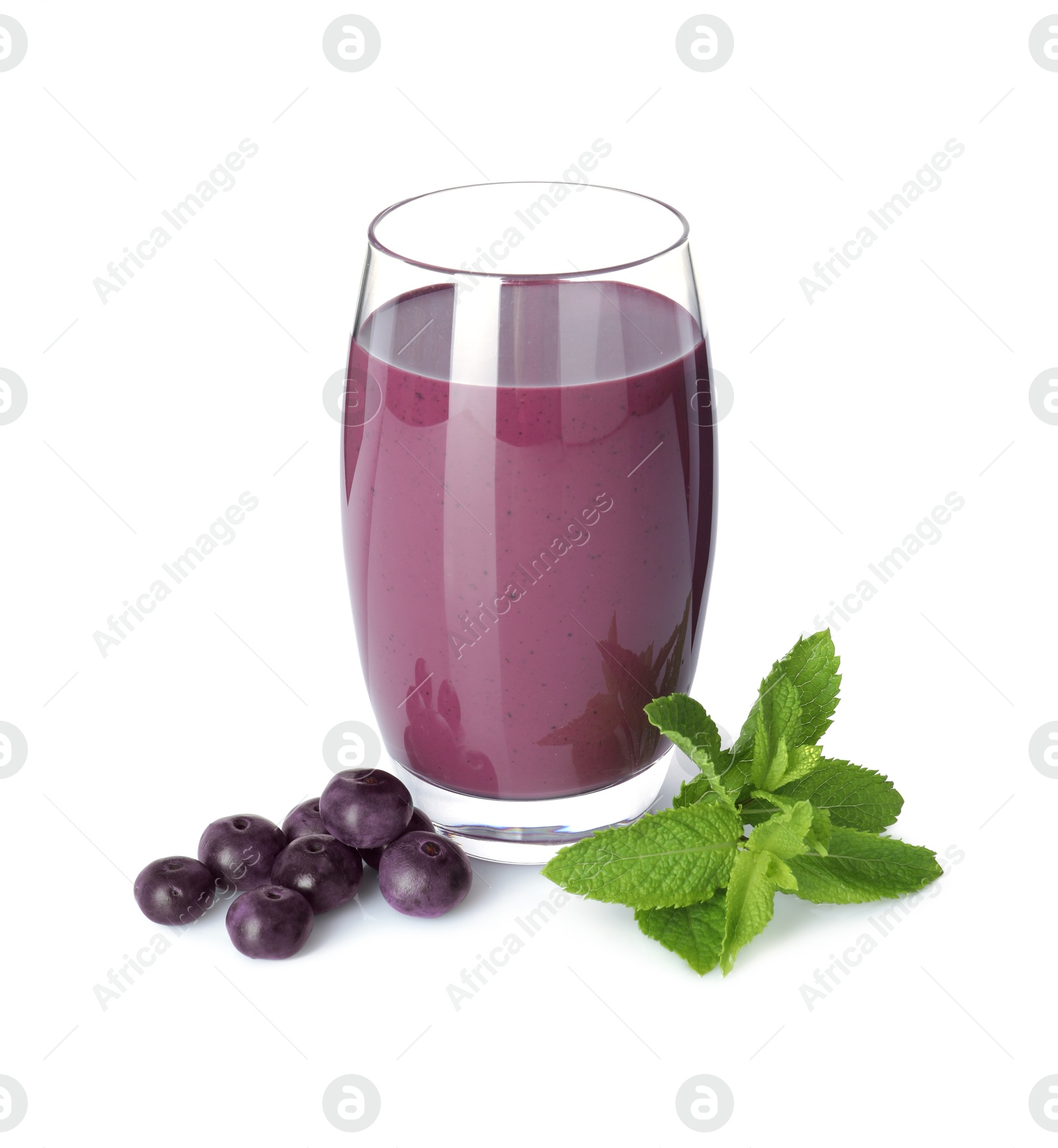 Photo of Tasty acai juice in glass, mint and berries isolated on white