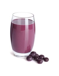 Photo of Tasty acai juice in glass and berries isolated on white