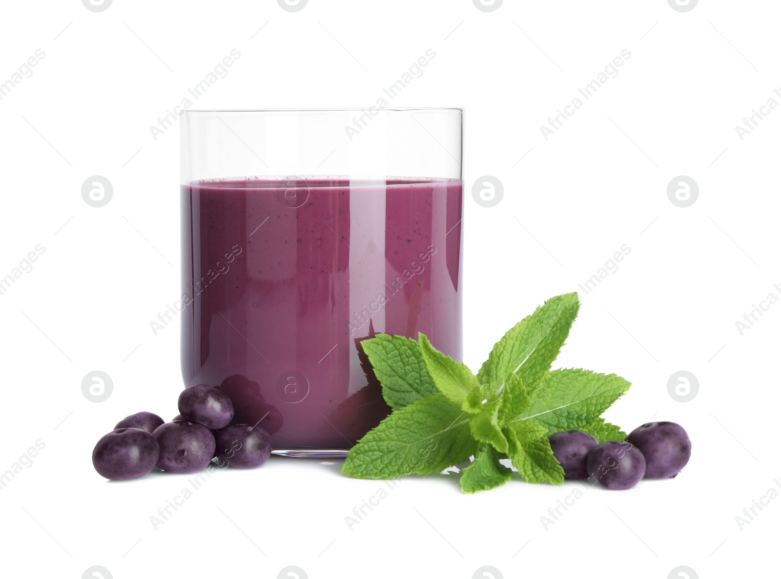 Photo of Tasty acai juice in glass, mint and berries isolated on white