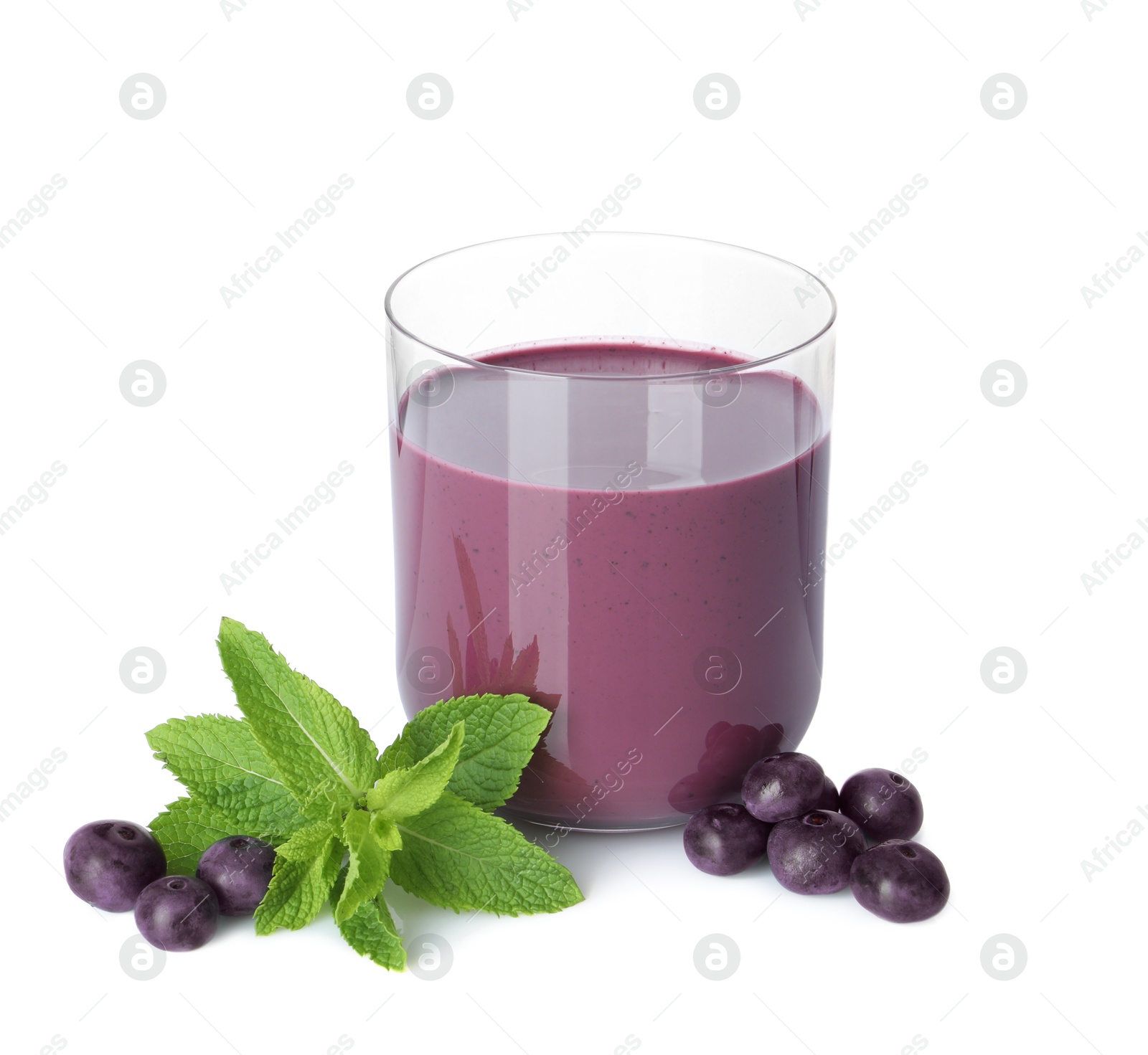 Photo of Tasty acai juice in glass, mint and berries isolated on white