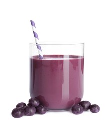 Tasty acai juice in glass and berries isolated on white