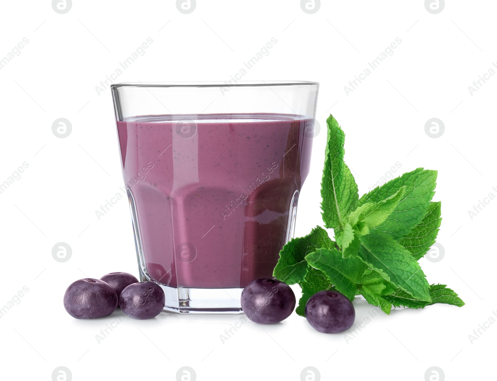 Photo of Tasty acai juice in glass, mint and berries isolated on white