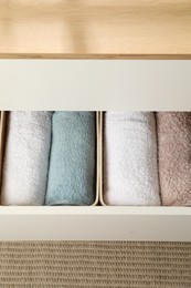 Photo of Chest of drawers with different folded clothes indoors, above view