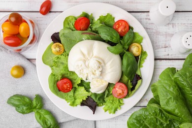 Delicious fresh burrata salad with ingredients on white wooden table, flat lay