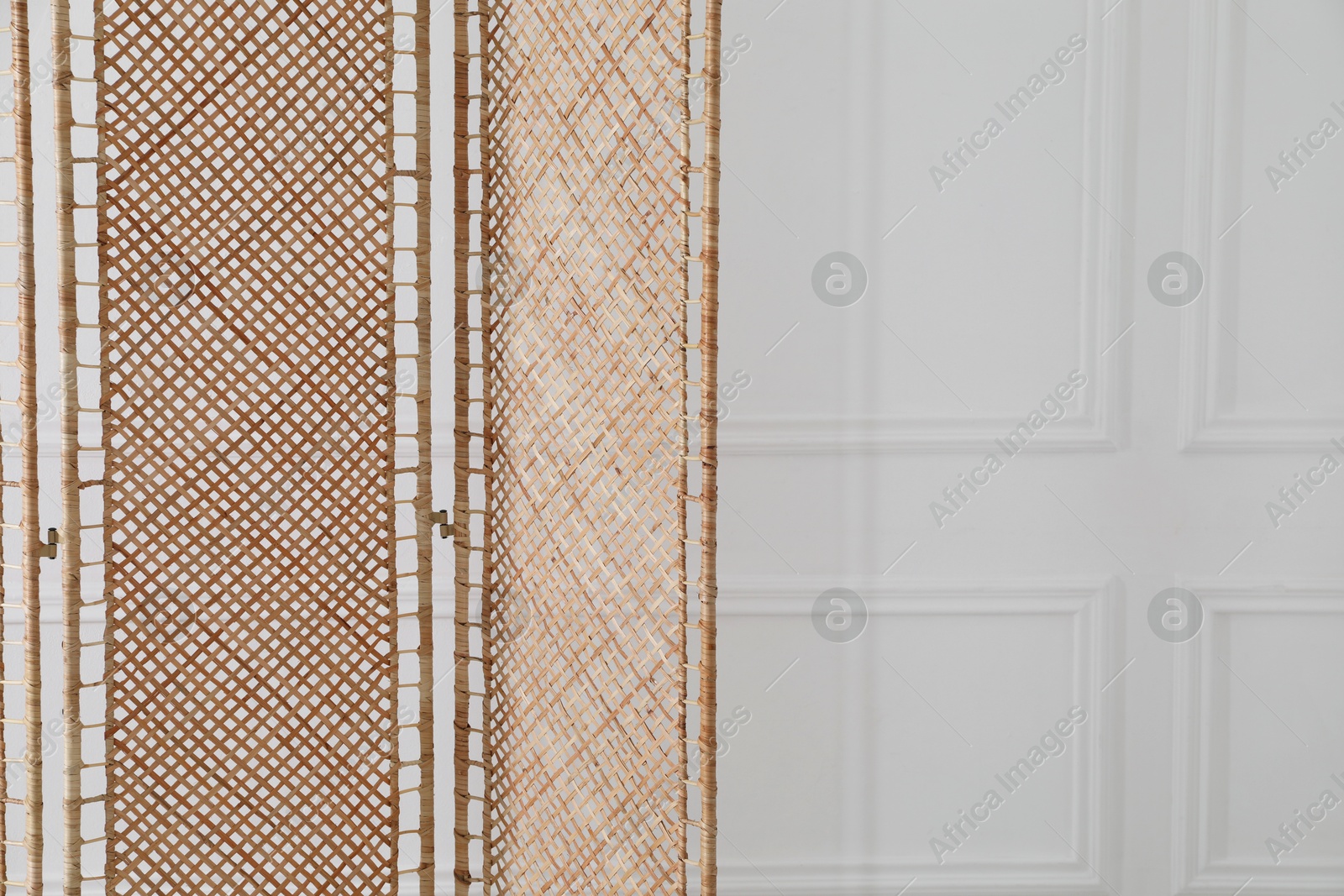 Photo of One folding screen near white wall indoors, space for text