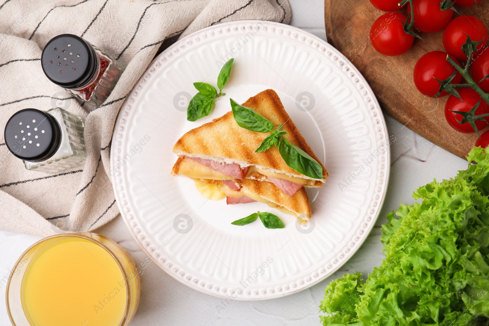 Photo of Pieces of toasted bread with melted cheese served on white table, top view