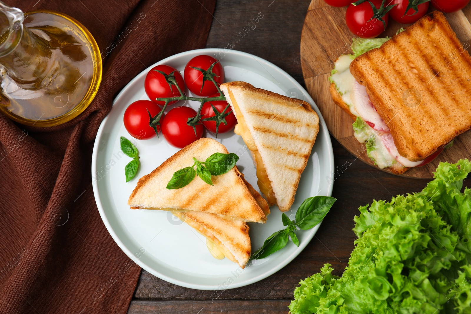 Photo of Pieces of toasted bread with melted cheese served on wooden table, top view