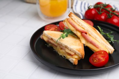 Photo of Pieces of toasted bread with melted cheese, ham and tomatoes on white tiled table