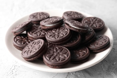 Photo of Many tasty sandwich cookies on light grey table