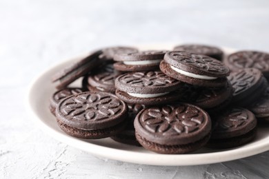 Photo of Many tasty sandwich cookies on light grey table, closeup