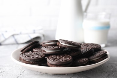 Many tasty sandwich cookies on light grey table