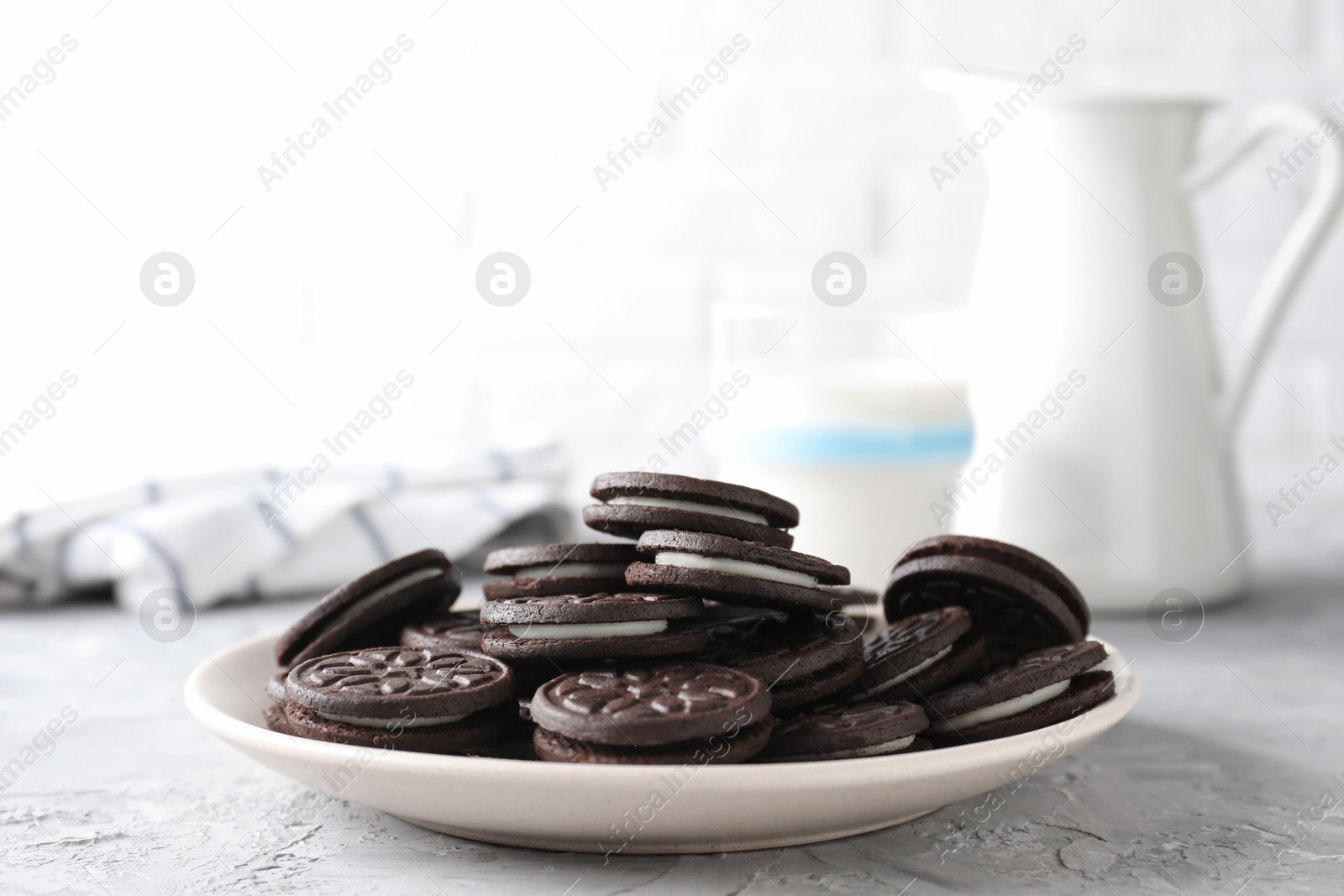 Photo of Many tasty sandwich cookies on light grey table