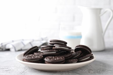 Many tasty sandwich cookies on light grey table