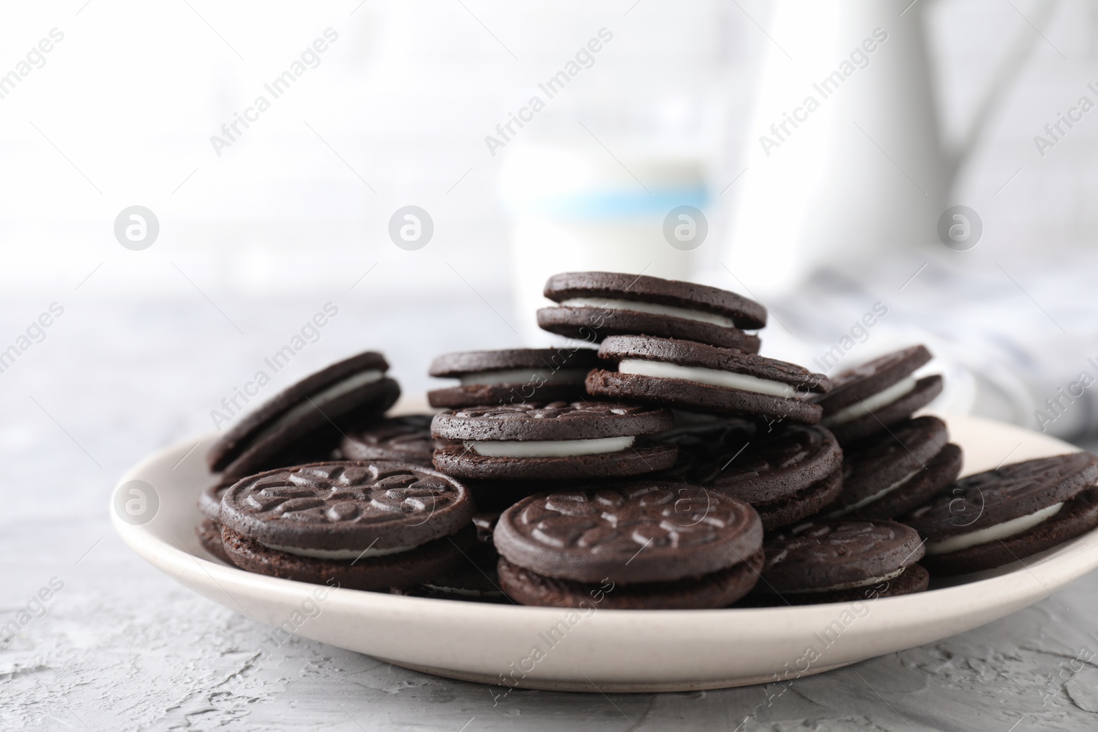 Photo of Many tasty sandwich cookies on light grey table